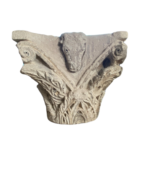 Romanesque capital sculpted on all sides.