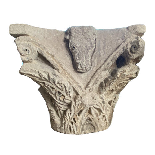 Romanesque capital sculpted on all sides.