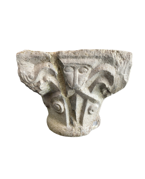 Romanesque capital decorated with masks.